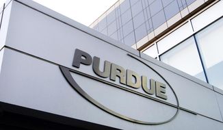 In this Tuesday, May 8, 2007, file photo, a Purdue Pharma logo is affixed to part of a Purdue building in Stamford, Conn. (AP Photo/Douglas Healey, File)