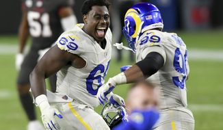 Los Angeles Rams nose tackle Sebastian Joseph-Day (69) celebrates with defensive end Aaron Donald (99) after the team defeated the Tampa Bay Buccaneers during an NFL football game Monday, Nov. 23, 2020, in Tampa, Fla. (AP Photo/Jason Behnken)