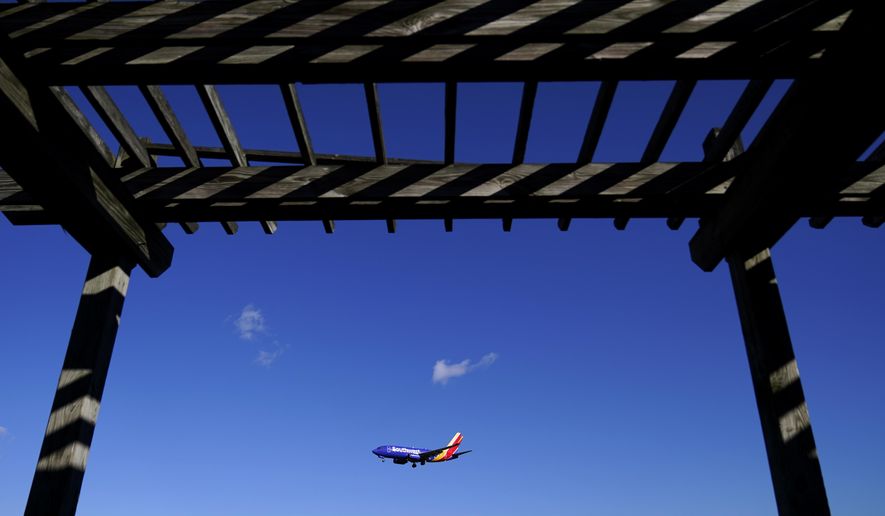 A shelter is seen at the Thomas Dixon Aircraft Observation Area as a Southwest Airlines flight from Jacksonville, Fla., makes its landing approach onto Baltimore-Washington International Thurgood Marshall Airport, Monday, Nov. 23, 2020, in Glen Burnie, Md.  With coronavirus cases spiking in the U.S. and Europe, the financial outlook of the world&#x27;s airlines is getting worse. The International Air Transport Association said Tuesday that around the world, airlines will lose more than $157 billion this year and next. (AP Photo/Julio Cortez)
