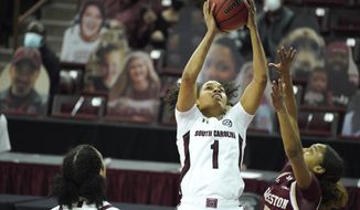 South Carolina guard Zia Cooke (1) attempts a shot over Charleston guard Madison Taylor (0) during the first half of an NCAA college basketball game Wednesday, Nov. 25, 2020, in Columbia, S.C. (AP Photo/Sean Rayford)