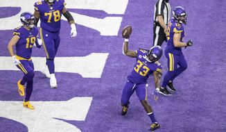 Minnesota Vikings running back Dalvin Cook (33) spikes the football after scoring on a 2-yard run against the Dallas Cowboys during an NFL football game in Minneapolis, Sunday, Nov. 22, 2020. (Jerry Holt/Star Tribune via AP)