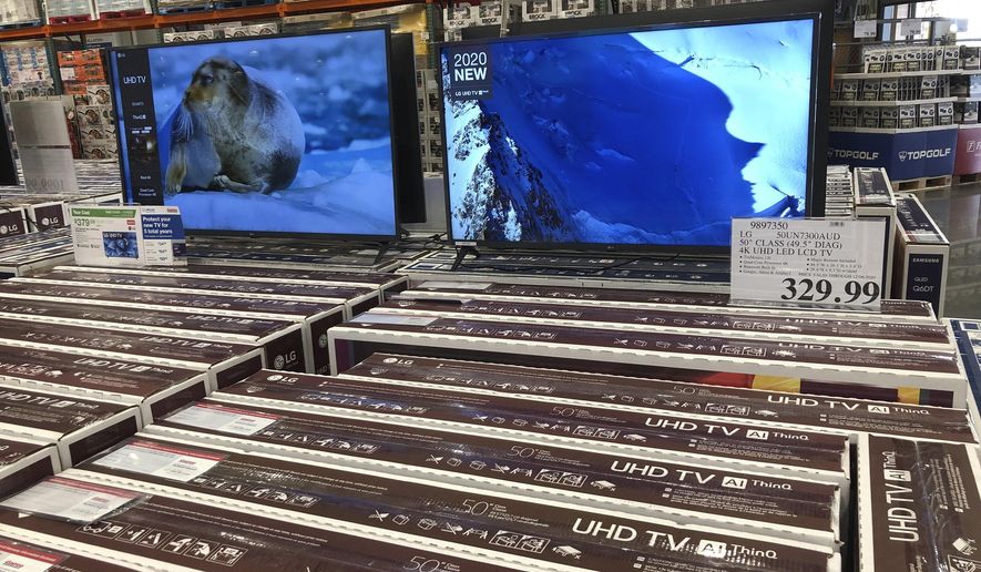Rows of boxed big-screen televisions sit on display at a Costco warehouse in this photograph taken Wednesday, Nov. 18, 2020, in Sheridan, Colo.   Orders for big-ticket manufactured goods slow to modest gain of 1.3% in October indicating economy is slowing. (AP Photo/David Zalubowski)