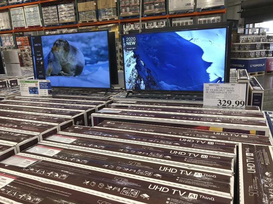 Rows of boxed big-screen televisions sit on display at a Costco warehouse in this photograph taken Wednesday, Nov. 18, 2020, in Sheridan, Colo.   Orders for big-ticket manufactured goods slow to modest gain of 1.3% in October indicating economy is slowing. (AP Photo/David Zalubowski)