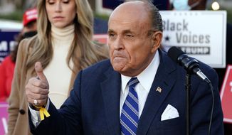 Rudy Giuliani, a lawyer for President Donald Trump, speaks during a news conference on legal challenges to vote counting in Pennsylvania, Wednesday, Nov. 4, 2020, in Philadelphia. At left is Lara Trump, daughter-in-law of President Trump. (AP Photo/Matt Slocum)