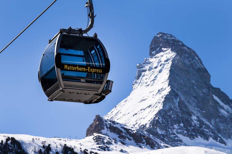 FILE  - In this Wednesday, March 18, 2020 file photo, a view of a &#39;Matterhorn-Express&#39; gondola lift in front of Matterhorn mountain in the  Zermatt ski resort, in Zermatt, Switzerland. Restrictions to slow the curve of coronavirus infections have kept ski lifts closed in Italy, France, Germany and Austria, as well as countries further east. But skiers are already heading to mountains in Switzerland, drawing an envious gaze from ski industry and local officials in mountain regions elsewhere on the continent who lost most of last season due to the virus. (Jean-Christophe Bott/Keystone via AP, File)