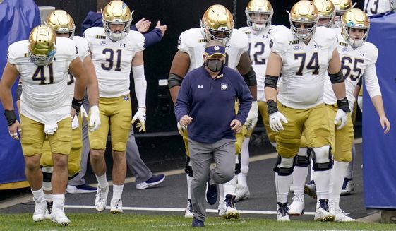 FILE - In this Oct. 24, 2020, file photo, Notre Dame head coach Brian Kelly, center, leads the team on to the field for an NCAA college football game against Pittsburgh in Pittsburgh. Kelly&#39;s second-ranked Fighting Irish visit No. 25 North Carolina on Friday. (AP Photo/Keith Srakocic, File)