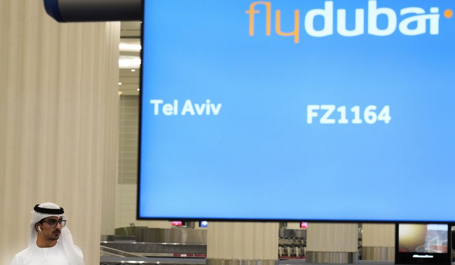 An Emirati journalist awaits a flyDubai flight from Tel Aviv, Israel, at Dubai International Airport&#x27;s Terminal 3 in Dubai, United Arab Emirates, Thursday, Nov. 26, 2020. The low-cost carrier flyDubai began regular flights to Tel Aviv on Thursday, the latest sign of the normalization deal between the United Arab Emirates and Israel. (AP Photo/Jon Gambrell)