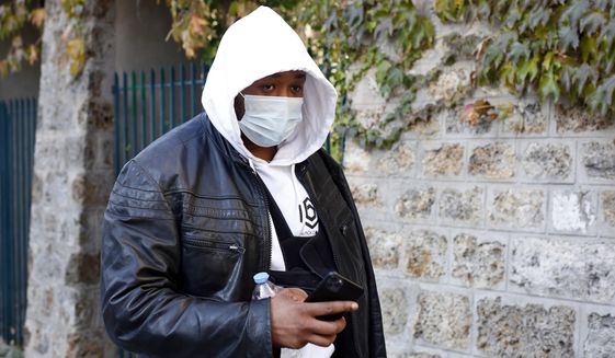 Music producer identified only by his first name, Michel, is pictured on his way to the Inspectorate General of the National Police, known by its French acronym IGPN, in Paris, Thursday, Nov. 26, 2020. French Interior Minister Gerald Darmanin ordered several Paris police officers suspended after the publication of videos showing them beating up a Black man and using tear gas against him with no apparent reason. (AP Photo/Thibault Camus)
