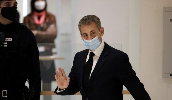 Former French President Nicolas Sarkozy arrives at the courtroom Thursday, Nov. 26, 2020 in Paris. Sarkozy goes on trial on charges of corruption and influence peddling in a phone-tapping scandal, a first for the 65-year-old politician who has faced several other judicial investigations since leaving office in 2012. (AP Photo/Christophe Ena)