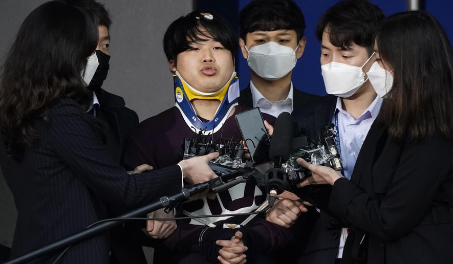FILE - In this March 25, 2020, file photo, Cho Ju-bin, center, leader of South Korea&#x27;s online sexual blackmail ring which is so called &amp;quot;Nth room,&amp;quot; is surrounded by journalists while walking out of a police station as he is transferred to prosecutors&#x27; office for further investigation in Seoul, South Korea. The operator of an online chat room in South Korea was sentenced Thursday, Nov. 26, to 40 years in prison for blackmailing women, including minors, into filming sexually explicit video and selling them to others.(Kim Hong-Ji/Pool Photo via AP, File)