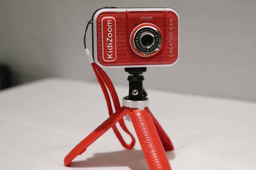 A KidiZoom Creator Cam by VTech is displayed at the Toy Fair, Thursday, Sept. 17, 2020, in New York. The digital camera comes with a green screen and animated backgrounds allowing kids to go to outer space, get chased by T-Rex, or make things disappear. The camera comes with a tabletop tripod, which can also be used as a selfie stick. (AP Photo/Kathy Willens)