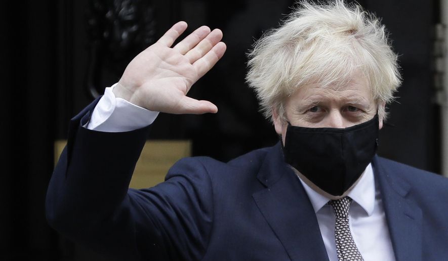 Britain&#39;s Prime Minister Boris Johnson waves as he leaves 10 Downing Street in London, Thursday, Nov. 26, 2020. Johnson leaves self-quarantine today after having close contact with a lawmaker who contracted the coronavirus in mid November. (AP Photo/Kirsty Wigglesworth)