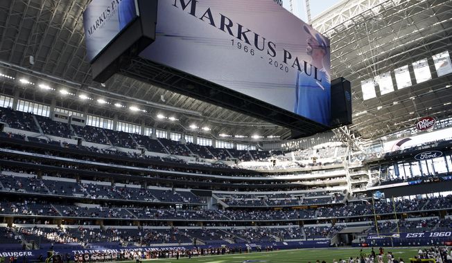 An image of Dallas Cowboys strength and conditioning coordinator Markus Paul is projected on the video screen as all in attendance observe a moment of silence before an NFL football game against the Washington Football Team in Arlington, Texas, Thursday, Nov. 26, 2020. Paul died on Wednesday. (AP Photo/Ron Jenkins)