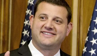 In this Jan. 6, 2015, file photo, Rep. David Valadao, R-Calif., poses during a ceremonial re-enactment of his swearing-in ceremony in the Rayburn Room on Capitol Hill in Washington. Valadao has reclaimed the U.S. House seat he lost in the California farm belt two years ago. (AP Photo/Jacquelyn Martin, File)  **FILE**