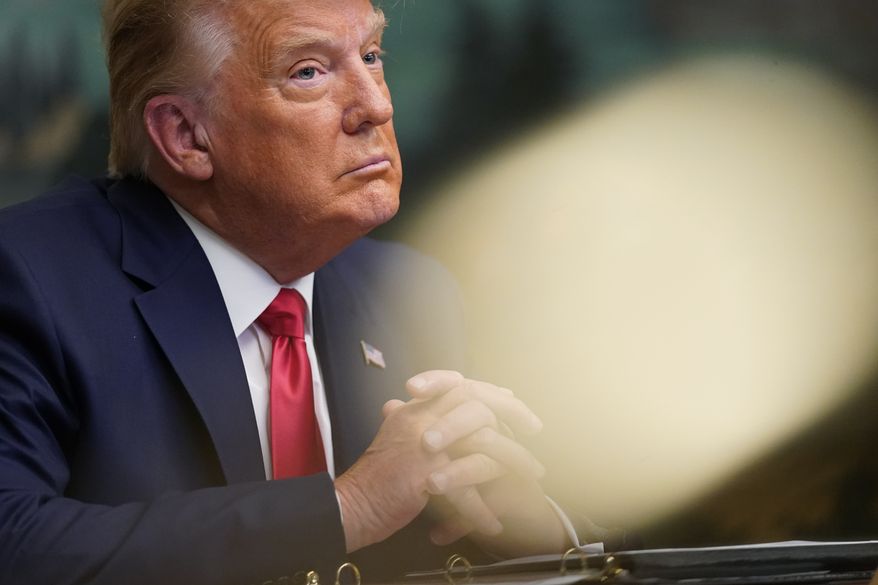 President Donald Trump participates in a video teleconference call with members of the military on Thanksgiving, Thursday, Nov. 26, 2020, at the White House in Washington. (AP Photo/Patrick Semansky)