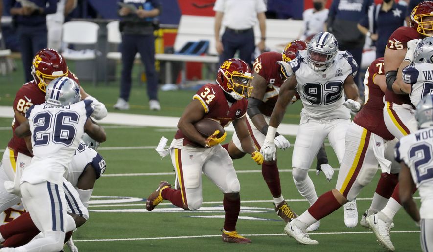 Washington Football Team running back Peyton Barber (34) looks for room to run during the first half of an NFL football game against the Dallas Cowboys in Arlington, Texas, Thursday, Nov. 26, 2020. (AP Photo/Roger Steinman)  **FILE**