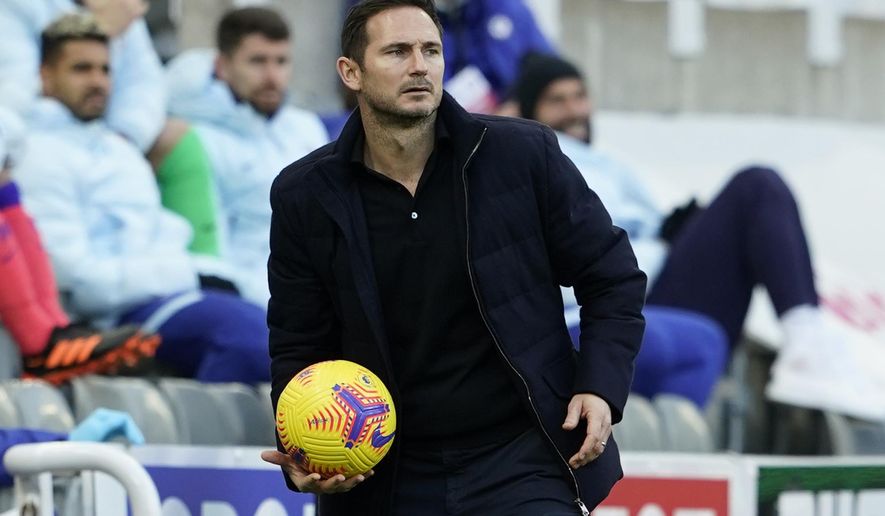 Chelsea&#39;s head coach Frank Lampard holds the ball during the English Premier League soccer match between Newcastle United v Chelsea at the St. James&#39; Park in Newcastle, England, Saturday, Nov. 21, 2020. (Owen Humphreys/Pool via AP)