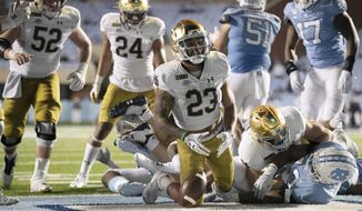 Notre Dame&#39;s Kyren Williams (23) reacts after scoring on a 1-yard carry against North Carolina during an NCAA college football game Friday, Nov. 27, 2020, in Chapel Hill, N.C. (Robert Willett/The News &amp;amp; Observer via AP, Pool)
