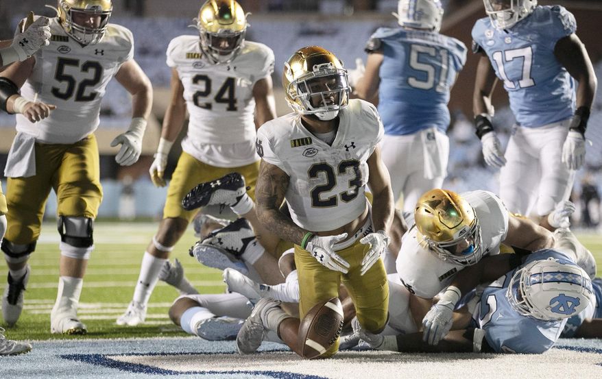 Notre Dame&#39;s Kyren Williams (23) reacts after scoring on a 1-yard carry against North Carolina during an NCAA college football game Friday, Nov. 27, 2020, in Chapel Hill, N.C. (Robert Willett/The News &amp;amp; Observer via AP, Pool)