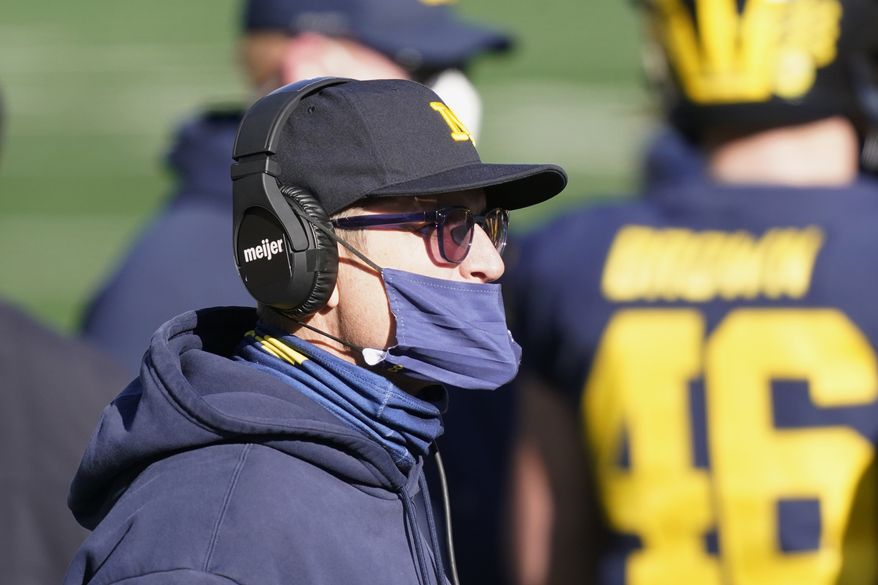 Michigan head coach Jim Harbaugh watches during the first half of an NCAA college football game against Penn State, Saturday, Nov. 28, 2020, in Ann Arbor, Mich. (AP Photo/Carlos Osorio) **FILE**