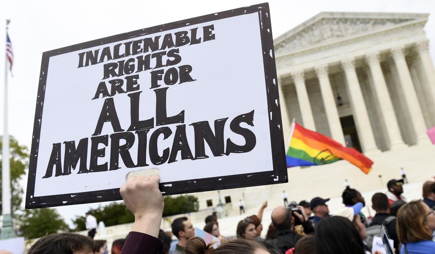 In this Oct. 8, 2019, photo, protesters gather outside the Supreme Court in Washington where the Supreme Court is hearing arguments in the first case of LGBT rights since the retirement of Supreme Court Justice Anthony Kennedy. As vice president in 2012, Joe Biden endeared himself to many LGBTQ Americans by endorsing same-sex marriage even before his boss, President Barack Obama. Now, as president-elect, Biden is making sweeping promises to LGBTQ activists, proposing to carry out virtually every major proposal on their wish lists. (AP Photo/Susan Walsh) **FILE**