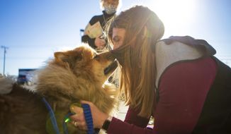 Melissa Buescher gives a kiss to her chow Leo after being reunited with him on Friday, Nov. 20, 2020, at Yellowstone Valley Animal Shelter in Billings, Mont. Buescher flew from Minneapolis to reunite with her dog after he got lost during an early October hike near Mystic Lake in the Beartooth Mountains. (Ryan Berry/The Billings Gazette via AP)