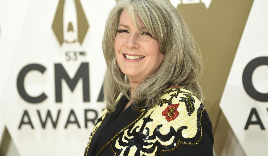 FILE - In this Nov. 13, 2019 file photo, Kathy Mattea arrives at the 53rd annual CMA Awards at Bridgestone Arena in Nashville, Tenn.  The country music star, who returned to West Virginia this Nov. 2020,  to host Mountain Stage for its second live, audience-free, streaming-only show at the Culture Center Theater in Charleston — bought a house with her husband, Jon Vezner, the year before.(Photo by Evan Agostini/Invision/AP, File)
