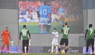 An image of Diego Armando Maradona is projected on a giant screen prior to the Serie A soccer match between Sassuolo and Inter Milan at the Mapei Stadium in Reggio emilia, Italy, Saturday, Nov. 28, 2020. (Massimo Paolone/LaPresse via AP)