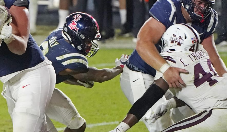 Mississippi running back Jerrion Ealy (9) follows his blockers as he rushes for an 8-yard touchdown during the second half of an NCAA college football game against Mississippi State, Saturday, Nov. 28, 2020, in Oxford, Miss. Mississippi won 31-24. (AP Photo/Rogelio V. Solis)