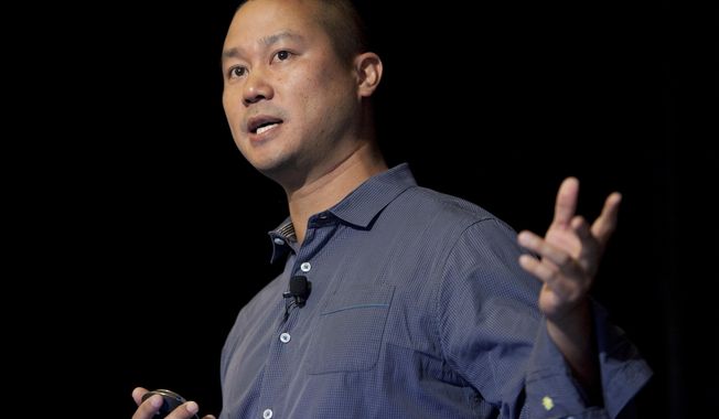 FILE - In this Sept. 30, 2013, file photo, Tony Hsieh speaks during a Grand Rapids Economic Club luncheon in Grand Rapids, Mich. Hsieh, retired CEO of Las Vegas-based online shoe retailer Zappos.com, has died. Hsieh was with family when he died Friday, Nov. 27, 2020, according to a statement from DTP Companies, which he founded. Downtown Partnership spokesperson Megan Fazio says Hsieh passed away in Connecticut, KLAS-TV reported. Hsieh recently retired from Zappos after 20 years leading the company. He worked to revitalize the Las Vegas area. (Cory Morse/The Grand Rapids Press via AP, File)