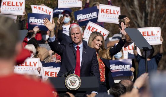  In this Nov. 20, 2020, file photo Vice President Mike Pence and Kelly Loeffler wave to the crowd during a Defend the Majority Rally in Canton, Ga. U.S. Sen. Kelly Loeffler waves behind Pence. (AP Photo/Ben Gray, File) ** FILE **