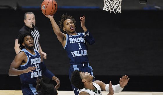 Rhode Island&#39;s Fatts Russell shoots as South Florida&#39;s David Collins, lower right, defends during the first half of an NCAA college basketball game Saturday, Nov. 28, 2020, in Uncasville, Conn. (AP Photo/Jessica Hill)