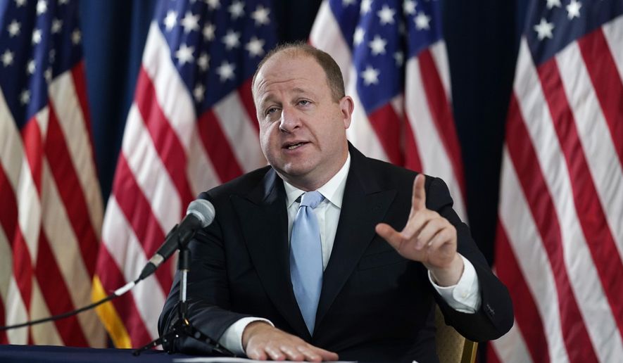 FILE - Colorado Gov. Jared Polis speaks during a news conference about the state&#39;s response to the rapid increase in COVID-19 cases, Tuesday, Nov. 24, 2020, in Denver.  Faulting inaction in Washington, governors and state lawmakers are racing to get needed pandemic relief to small businesses, the unemployed, renters and others affected by the widening coronavirus outbreak.   (AP Photo/David Zalubowski, File)