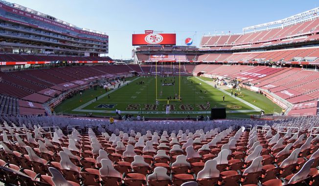 This Oct. 4, 2020, file photo, taken with a fisheye lens, shows an empty Levi&#x27;s Stadium before an NFL football game between the San Francisco 49ers and the Philadelphia Eagles in Santa Clara, Calif. The 49ers and other teams may need to find a temporary new home after Santa Clara County on Saturday, Nov. 28, 2020, banned all contact sports from holding games and practices for the next three weeks. County officials issued the directives in response to rising cases of the coronavirus in the area. The rules take effect Monday and will last for three weeks.  (AP Photo/Tony Avelar, File)