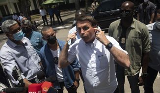 Brazil&#39;s President Jair Bolsonaro talks with the media outside a polling station, after voting during the run-off municipal elections in Rio de Janeiro, Brazil, Sunday, Nov. 29, 2020. Bolsonaro, who sometimes has embraced the label &quot;Trump of the Tropics,&quot; said Sunday he&#39;ll wait a little longer before recognizing the U.S. election victory of Joe Biden, while also echoing President Donald Trump&#39;s allegations of irregularities in the U.S. vote. (AP Photo/Silvia Izquierdo) ** FILE **