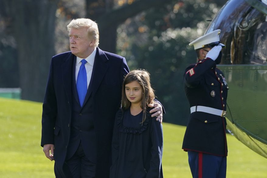 President Donald Trump walks with his granddaughter Arabella Kushner on the South Lawn of the White House in Washington, Sunday, Nov. 29, 2020, after stepping off Marine One. President Trump is returning from Camp David. (AP Photo/Patrick Semansky)