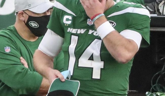 New York Jets quarterback Sam Darnold (14) puts on a cap after he threw an interception, his second of the game, in the fourth quarter against the Miami Dolphins on Sunday, Nov. 29, 2020, in East Rutherford, N.J. (Andrew Mills/NJ Advance Media via AP)