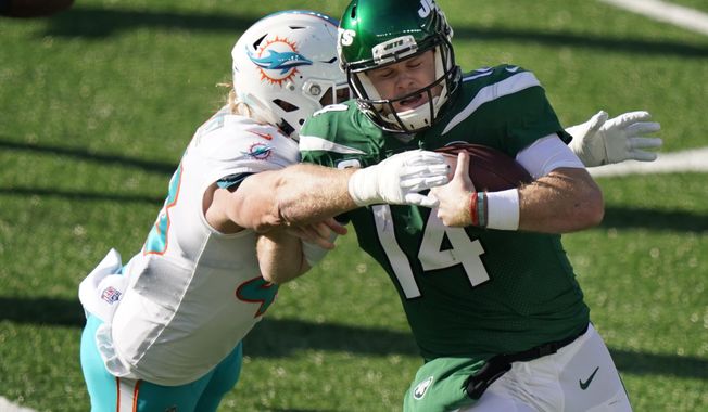 Miami Dolphins&#x27; Andrew Van Ginkel, left, tackles New York Jets quarterback Sam Darnold during the first half of an NFL football game, Sunday, Nov. 29, 2020, in East Rutherford, N.J. (AP Photo/Corey Sipkin)