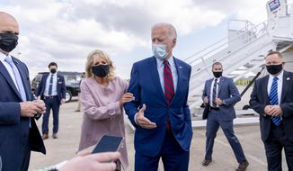 FILE - In this Oct. 5, 2020 file photo, Jill Biden moves her husband, Democratic presidential candidate former Vice President Joe Biden, back from members of the media as he speaks outside his campaign plane at New Castle Airport in New Castle, Del., to travel to Miami for campaign events. Protecting Joe stands out among Jill Biden&#39;s many roles over their 43-year marriage, as her husband&#39;s career moved him from the Senate to the presidential campaign trail and the White House as President Barack Obama&#39;s vice president. She&#39;s a wife, mother, grandmother and educator with a doctoral degree — as well as a noted prankster who will soon be putting her own stamp on what it means to be first lady. (AP Photo/Andrew Harnik, File)