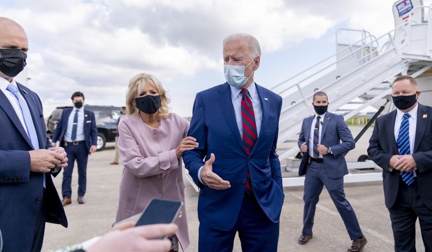 FILE - In this Oct. 5, 2020 file photo, Jill Biden moves her husband, Democratic presidential candidate former Vice President Joe Biden, back from members of the media as he speaks outside his campaign plane at New Castle Airport in New Castle, Del., to travel to Miami for campaign events. Protecting Joe stands out among Jill Biden&#x27;s many roles over their 43-year marriage, as her husband&#x27;s career moved him from the Senate to the presidential campaign trail and the White House as President Barack Obama&#x27;s vice president. She&#x27;s a wife, mother, grandmother and educator with a doctoral degree — as well as a noted prankster who will soon be putting her own stamp on what it means to be first lady. (AP Photo/Andrew Harnik, File)