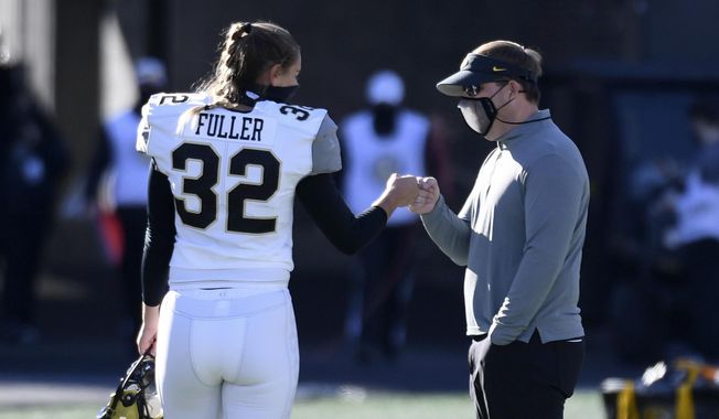 Vanderbilt place kicker Sarah Fuller (32) gets a fist-bump from Missouri head coach Eliah Drinkwitz after warming up before an NCAA college football game Saturday, Nov. 28, 2020, in Columbia, Mo. (AP Photo/L.G. Patterson) **FILE**