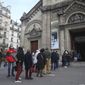 Church-goers wearing face masks as a precaution against the coronavirus lineup outside the Notre-Dame-des-Champs church in Paris, Sunday, Nov. 29, 2020. French churches, mosques and synagogues can open their doors again to worshippers - but only a few of them, as France cautiously starts reopening after a second virus lockdown. Some churches may defy the 30-person limit they feel as too unreasonable, and other sites may stay closed until they can reopen for real. (AP Photo/Michel Euler)