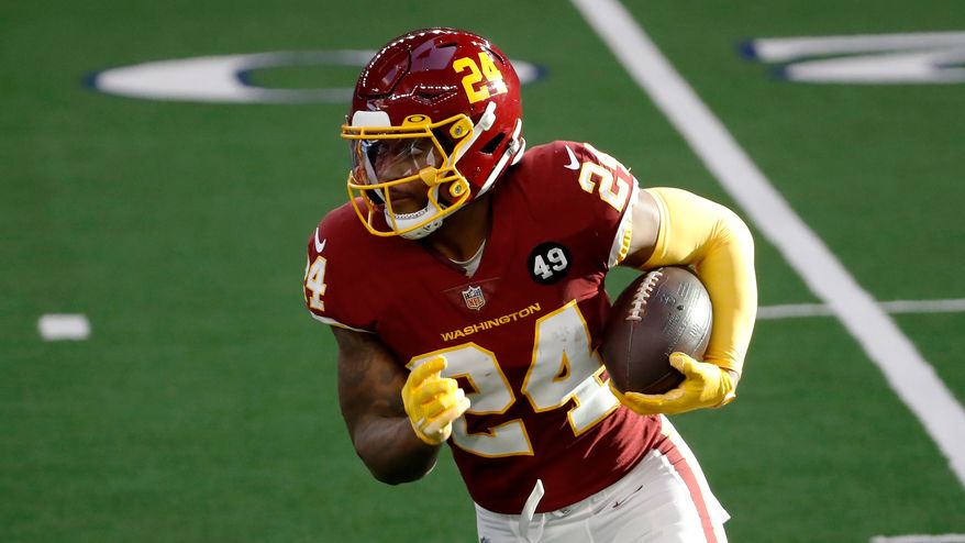 Washington Football Team running back Antonio Gibson (24) carries the ball against the Dallas Cowboys in the first half of an NFL football game in Arlington, Texas, Thursday, Nov. 26, 2020. (AP Photo/Roger Steinman)