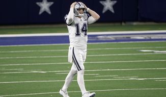Dallas Cowboys quarterback Andy Dalton (14) grabs his helmet after throwing an incomplete pass into the end zone in the second half of an NFL football game against the Washington Football Team in Arlington, Texas, Thursday, Nov. 26, 2020. (AP Photo/Roger Steinman)