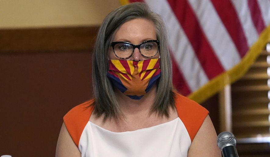 Arizona Secretary of State Katie Hobbs reads a statement prior to certifying the election results for federal, statewide, and legislative offices and statewide ballot measures at the official canvass at the Arizona Capitol Monday, Nov. 30, 2020, in Phoenix. (AP Photo/Ross D. Franklin, Pool)