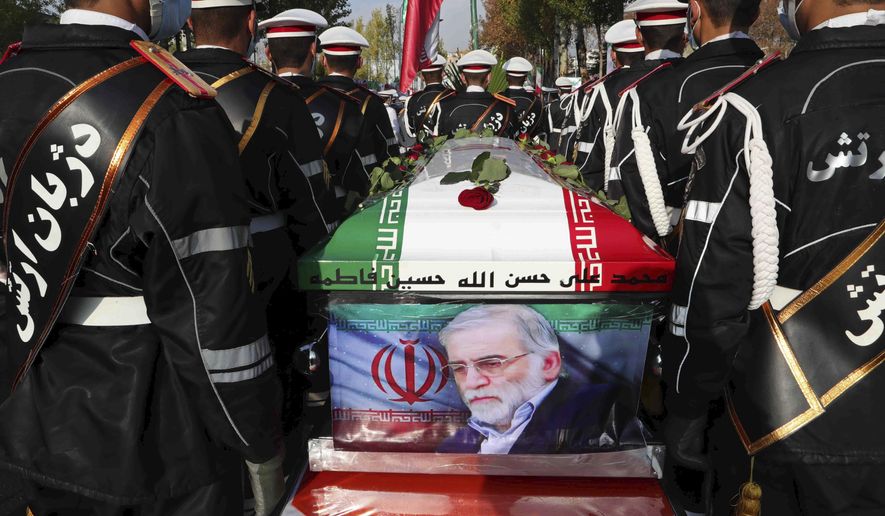 In this photo released by the official website of the Iranian Defense Ministry, military personnel stand near the flag-draped coffin of Mohsen Fakhrizadeh, a scientist who was killed on Friday, during a funeral ceremony in Tehran, Iran, Monday, Nov. 30, 2020. Fakhrizadeh founded Iran&#39;s military nuclear program two decades ago, and the Islamic Republic&#39;s defense minister vowed to continue the man&#39;s work &amp;quot;with more speed and more power.&amp;quot; (Iranian Defense Ministry via AP)