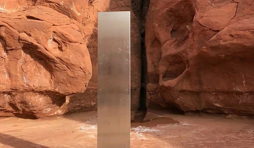 FILE - This Nov. 18, 2020, file photo provided by the Utah Department of Public Safety shows a metal monolith in the ground in a remote area of red rock in Utah. The mysterious silver monolith that was placed in the Utah desert has disappeared less than 10 days after it was spotted by wildlife biologists performing a helicopter survey of bighorn sheep, federal officials and witnesses said. The Bureau of Land Management said it had received credible reports that the three-sided stainless steel structure was removed on Nov. 27. (Utah Department of Public Safety via AP, File)
