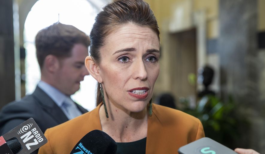 New Zealand Prime Minister Jacinda Ardern speaks during a media stand-up on her way to Question Time at Parliament, in Wellington, New Zealand Tuesday, Dec. 1, 2020. New Zealand has joined Australia in denouncing a graphic tweet posted by a Chinese official that shows a fake image of a grinning Australian soldier holding a bloodied knife to a child’s throat. (Mark Mitchell/NZ Herald via AP)