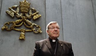 FILE - In this June 29, 2017, file photo, Cardinal George Pell prepares to make a statement, at the Vatican. Cardinal George Pell, who was convicted and then acquitted of sexual abuse in his native Australia, reflects on the nature of suffering, Pope Francis’ papacy and the humiliations of solitary confinement in his jailhouse memoir, according to an advance copy obtained by The Associated Press. (AP Photo/Gregorio Borgia, File)