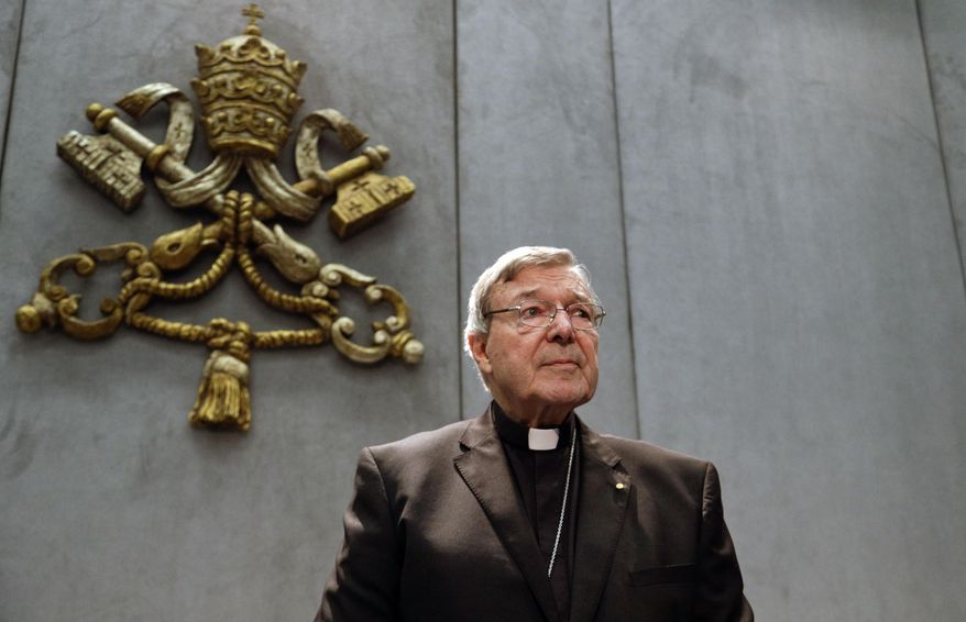FILE - In this June 29, 2017, file photo, Cardinal George Pell prepares to make a statement, at the Vatican. Cardinal George Pell, who was convicted and then acquitted of sexual abuse in his native Australia, reflects on the nature of suffering, Pope Francis’ papacy and the humiliations of solitary confinement in his jailhouse memoir, according to an advance copy obtained by The Associated Press. (AP Photo/Gregorio Borgia, File)